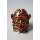A LATE 19TH / EARLY 20TH TREACLE GLAZE MONEY BANK IN THE FORM OF A MONKEYS HEAD A/F, H 7 cm
