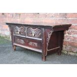 A CHINESE ANTIQUE ELM LOW TABLE, possible Qing Dynasty, having two short drawers, carved floral