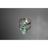 A HALLMARKED 18 CARAT WHITE GOLD GEM SET RING, set with a light green oval stone, ring size N