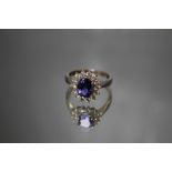 A PLATINUM SET TANZANITE AND DIAMOND RING, having a central oval Tanzanite of an estimated 2 carats,