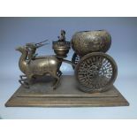 AN ORIENTAL THEMED BRASS CARRIAGE, the carriage being in the form of a globular pot with floral