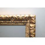 A 19TH CENTURY STYLE CARVED WOODEN GOLD FRAME, rebate 80 x 60 cm, width of frame 9 cm