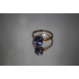 A HALLMARKED 18 CARAT WHITE GOLD TANZANITE AND DIAMOND RING, the oval Tanzanite being an estimated 2