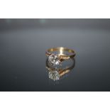 A NEAR COLOURLESS BRILLIANT CUT DIAMOND SOLITAIRE IN HALLMARKED 18 CARAT GOLD, the brilliant cut