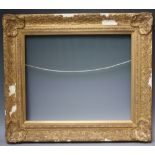 A LATE 20TH / EARLY 21ST CENTURY DECORATIVE GOLD FRAME, with corner embellishments (A/F), with