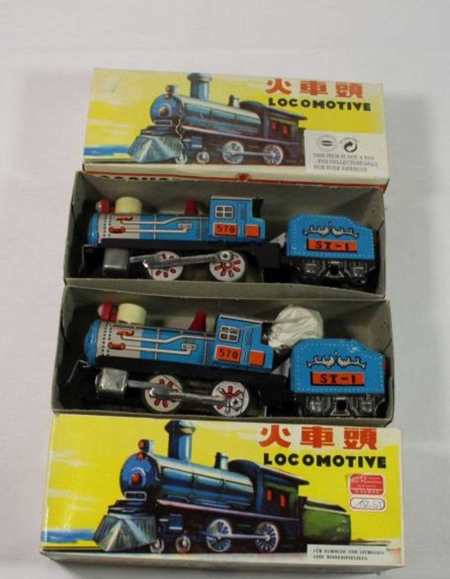 2x Blech-Lokomotiven, China, orig. Kartons, je H-7,5cm L-19cm.