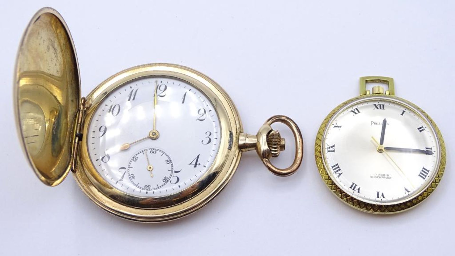 2 Taschenuhren, jeweils mit weißem Ziffernblatt, D. 54 mm und 40 mm, beide laufen an, 117,2