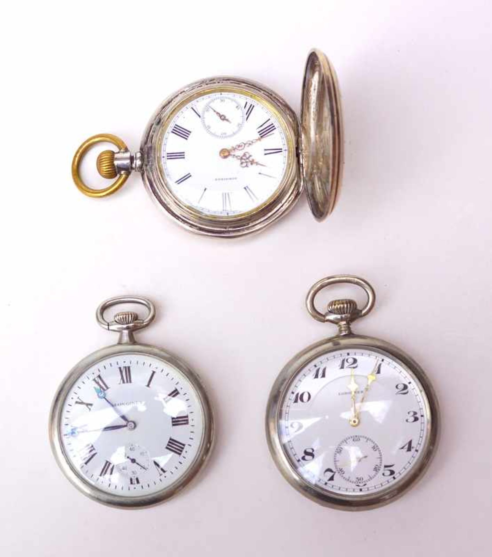 3 Longines Taschenuhren1 Savonette in Silber und 2 Nickelgehäuse 1. H. 20. Jhd., 1 Uhr mit Defekt (