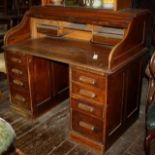 Early 20thC oak roll top office desk,