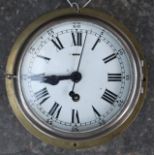 Antique ships clock in brass case and bevelled glass .