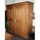 A large stripped pine 'knock down' wardrobe