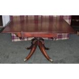 George III drop leaf sofa table in mahogany on quadrafoil base with original 'lion paw' castors.