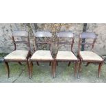 Set of four Regency chairs (to match lot 420) with sabre legs, drop in seat and brass string inlay