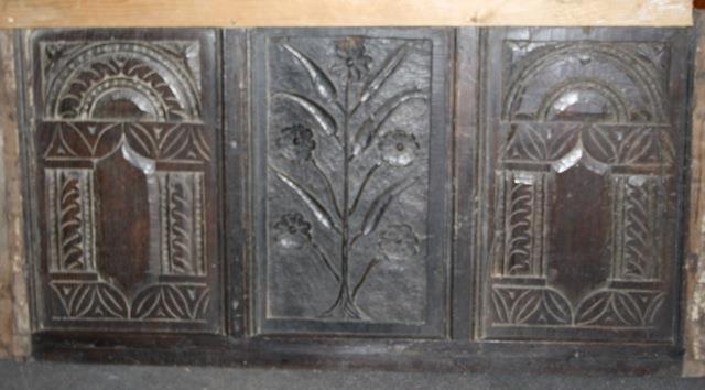 Ancient carved oak panel, arched motifs flanking floral centre
