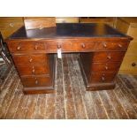 Victorian pine kneehole desk in original finish with nine drawers and on castors concealed within