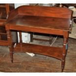 A Georgian mahogany washstand on turned legs with lower tier