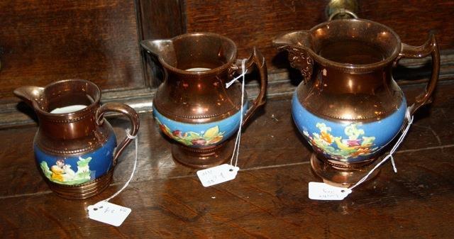 Three Victorian lustre ware jugs