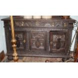 Heavily carved 16th C style oak buffet with cupboards under