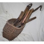 Wicker basket containing vintage gardening tools