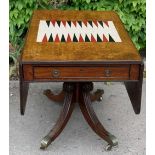 Regency drop leaf backgammon table raised on a pedestal base with quatrefoil sabre legs