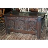 A good early medium sized 18th century oak coffer with original blind fretwork to three moulded