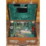 Fitted gentleman's travelling vanity case, green moire silk lining and outer canvas weather cover.