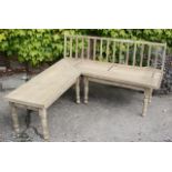 Large Victorian stripped pine corner seat in two sections with turned legs and slat back.