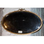 Oval wall mirror, Regency style, in brass frame
