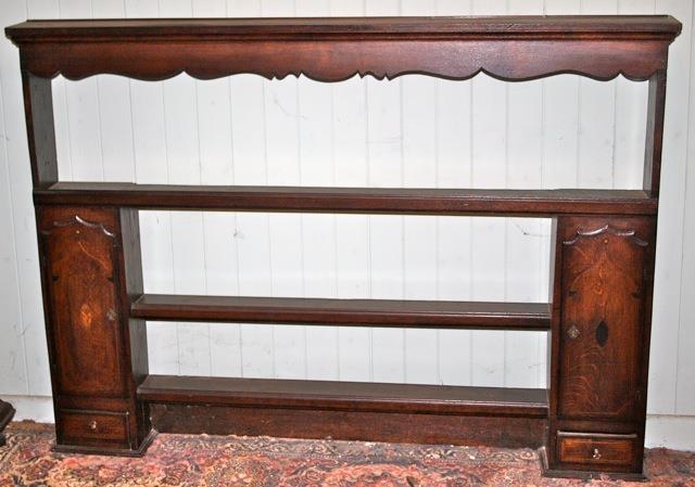Antique oak dresser rack with side cupboards and small drawer under each
