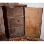 A small 18th C oak corner cupboard with original H brass hinges, panelled door and shaped shelves