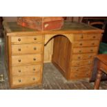 Large old stripped pine, leather topped, desk with 12 drawers