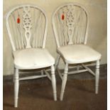A pair of early 20th C painted wheel back kitchen chairs