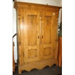 Eastern European stripped pine cupboard with deep blind fretwork decoration