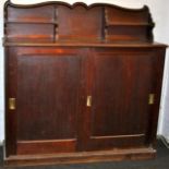 Old oak cabinet with sliding doors to base and shaped and shelved up stand