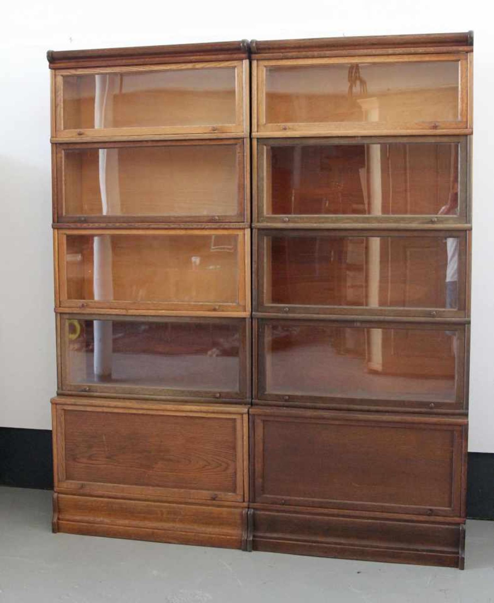 Zwei Leitz-Bücherregale, Modulsystem, Eichenholz, 1. H. 20. Jh.Basis mit Klappe aus Holz, darauf