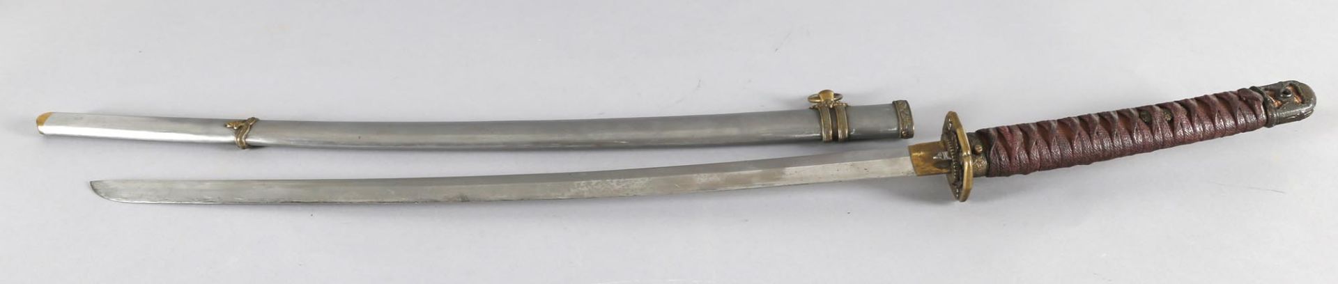 Katana Schwert, Japan, Anfang 20. Jh.leicht geschwungene einschneidige Klinge, Griff mit roten