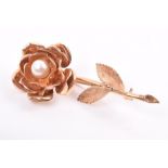 A yellow metal and pearl floral brooch the furled petals centred with a round white pearl, 6.7 cm