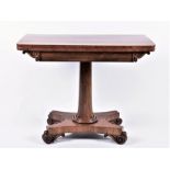 A Regency style mahogany fold-over card table  with carved frieze detail, opening to reveal a