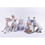 A collection of Lladro porcelain figures to include a model of the Virgin Mary, a boy with boat, a