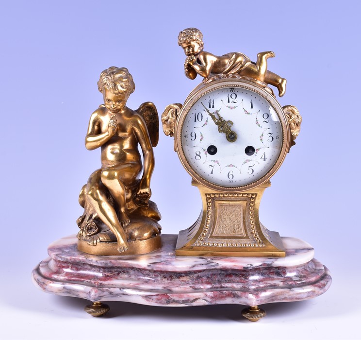 A 19th century French ormolu drum shaped mantel clock the white enamel dial with painted flowers,