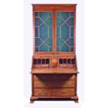 A George III mahogany bureau bookcase the top with astral glazed doors, the drop flap opening to