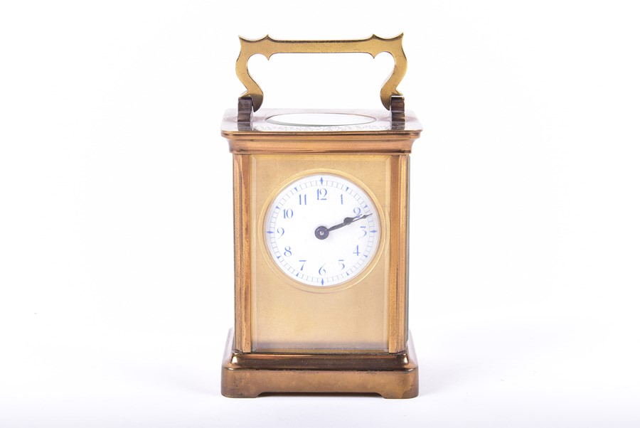 A brass bound Carriage clock with engraved inscription and enameled dial. - Image 4 of 4