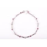 A 9ct white gold, diamond, and ruby bracelet comprised of collet-set rubies alternated with