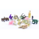 A collection of Asian hardstone animals and figures comprising amethyst, pink quartz, onyx and jade,