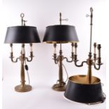 A set of three French Empire style bouillote lamps each with a toleware shade above three arms on