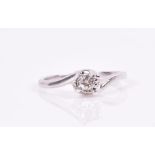 A 9ct white gold and solitaire diamond ring crossover set with a round brilliant-cut stone with a