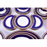 An extensive early 20th century Wedgwood part dinner service designed with a cobalt blue and gilt