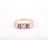 An 18ct yellow gold, diamond, and sapphire ring set with two old-cut diamonds of approximately 0.