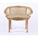 A small Louis XVI style giltwood fauteuil with caned curved back and upholstered seat above a