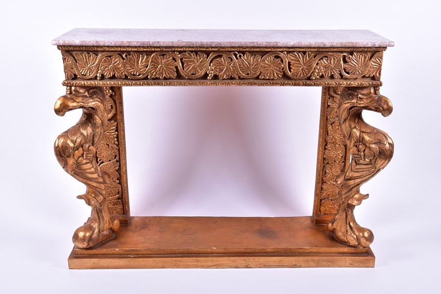 A reproduction gilt painted and marble-topped console table the front columns formed as stylised